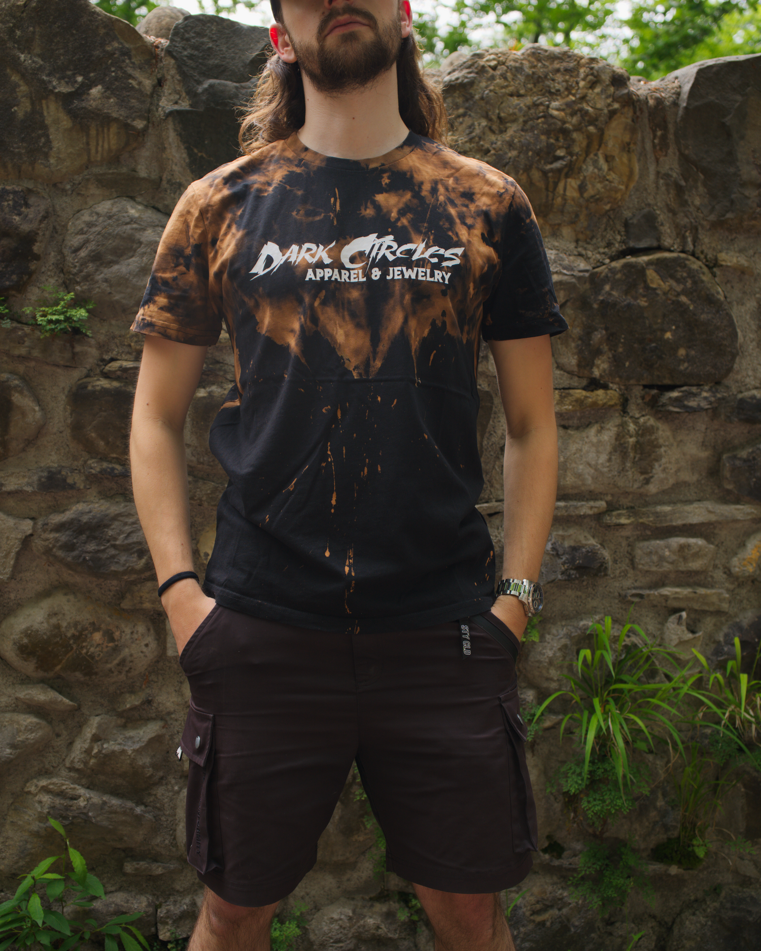 Person wearing a black custom bleached t-shirt with 'Dark Circles Apparel & Jewelry' logo.